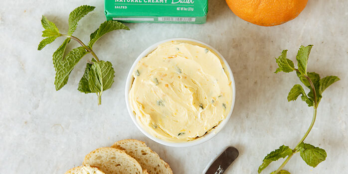 natural creamy butter being spread on bread