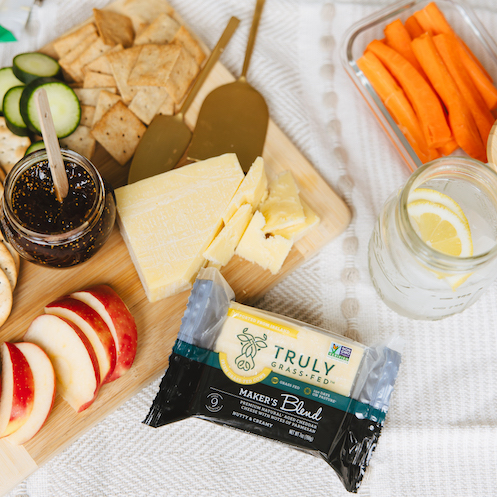 cheese board with truly grass fed makers blend cheddar wedge